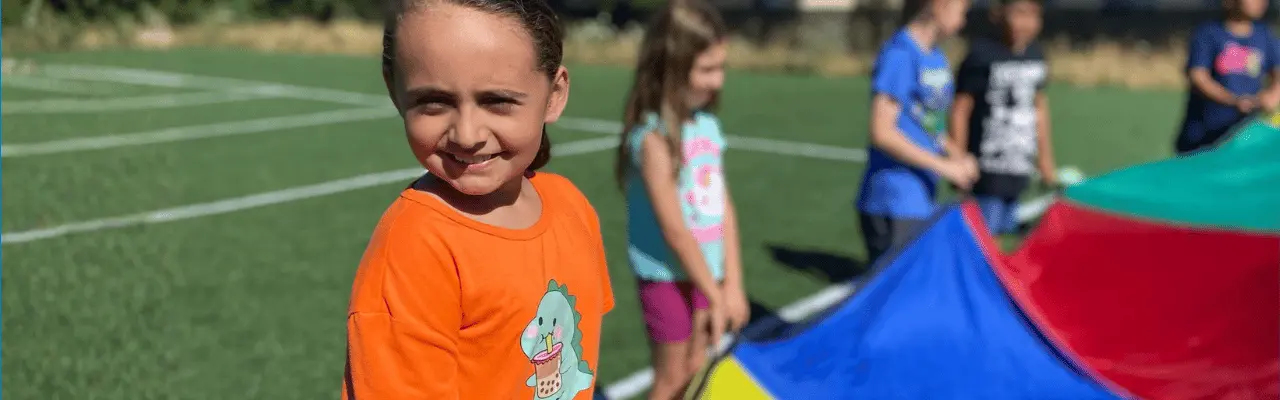 child smiling outside